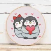 présentation toile point de croix Pingouins amoureux